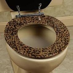 an animal print toilet seat cover with the lid up