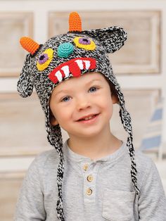 a young boy wearing a knitted hat with horns