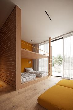 a bedroom with bunk beds and large windows next to a yellow couch in front of the bed