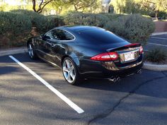 a black sports car parked in a parking lot