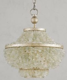 a chandelier hanging from a chain with white beads