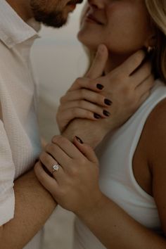 a man and woman standing next to each other with their hands on one another's chest