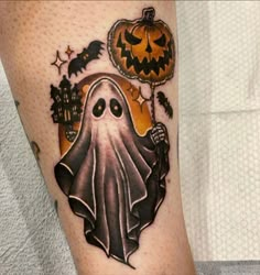 a halloween themed tattoo with a ghost holding a pumpkin and jack - o - lantern