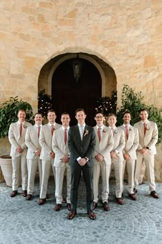 a group of men in suits standing next to each other