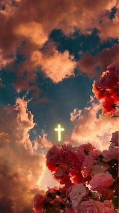 the sky is filled with clouds and pink flowers in front of a crucifix