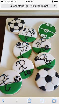 there are many decorated cookies with soccer balls on the top one is green and white