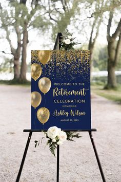 a welcome sign with gold balloons and confetti on it in front of trees