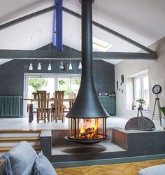 a living room filled with furniture and a fire place in the middle of it's fireplace