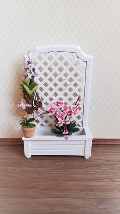 two potted plants sitting on top of a white bench