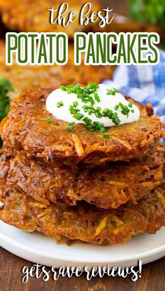 crispy potato pancakes on a white plate with sour cream and chives in the middle