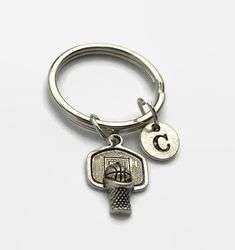 This basketball keychain is the perfect accessory for anyone who loves playing basketball or watching basketball. It is a stylish keychain that can be worn with just about anything.Charms are made from a zinc alloy metal which is lead and nickel free. Each purchase will arrive packaged in a cute kraft gift box ready to give as a present or a fun gift for yourself!Add on a birthstone charm for $3.00Additional initial charm $3.50 *Go back to OurLittleCharmshttps://www.etsy.com/shop/ourlittlecharms Basketball Keychain, Wife Jewelry, Basketball Gifts, Playing Basketball, Basketball Coach, Coach Gift, Kraft Gift Boxes, Simple Bracelets, Coach Gifts