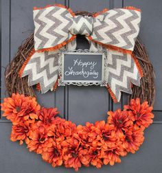 a happy thanksgiving wreath with orange flowers and a chalkboard sign on the front door