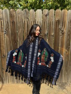 This beautiful Traditional Shawl is completely unique in both design and embroidery.  Beautiful traditional Virgin Mary design and has tassels at the end. (Colors may vary as they uniquely made although same design)  This Shawl can be used  like a wrap around blanket, blanket , table runner, gift,  it is warm, comfortable and stylish.  One Size Fits All SIZE  WIDTH 31 inches  LENGTH 87 inches More colors available  https://www.etsy.com/listing/1310666562/mexican-embroidered-shawl-virgin-mary?cli Bohemian Cotton Shawl With Embroidered Border, Traditional Cotton Dupatta With Tassels, Festival Embroidered Cotton Shawl, Traditional Poncho With Floral Embroidery, Traditional Embroidered One-size Shawl, Mexican Shawl, Traditional Floral Embroidered Poncho, Mexican Blanket Poncho, Black Embroidered Bohemian Shawl