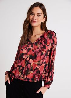 This shirred raglan tie front floral blouse is a versatile long sleeve top featuring a flattering v-neckline, perfect for any occasion. With a flowy fit, this blouse is comfortable to wear and easy to style, making it a must-have piece for your wardrobe this season. Ideal for both casual and dressy looks, this top is a timeless addition to any outfit. 100% Rayon Bella Dahl, Cardigan Sweater Dress, Tie Front Blouse, Dress The Population, Sweater Gift, Sweater Sale, Sheer Fabrics, Floral Blouse, Jacket Tops