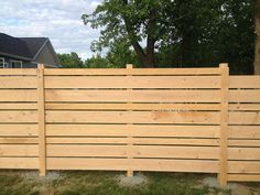 a wooden fence in front of a house