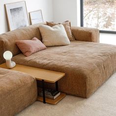 a living room with a brown couch and coffee table