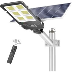 the solar powered street light is attached to a pole with a remote control on it