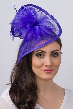 Stunning from every angle. This mesh twist fascinator has a look that’s both daring and elegant. This statement-making fascinator headband rises to the occasion with a twist mesh base, fluffy bouquet of flighty feathers all on an easy to wear headband with precision placement. This is a modern twist on the loved fascinator. - Light weight - Attached to headband for easy wear - Comes in several other bold colors Elegant Purple Fascinator For Summer, Fluffy Bouquet, Luxury Purple Fascinator For Spring, Purple Summer Fascinator, High Tea Hat, Purple Evening Fascinator With Curved Brim, Headpiece Ideas, Royal Blue Fascinator, Art Hats