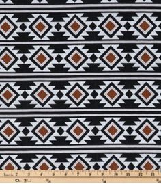 a black and white pattern with brown squares on it, in front of a ruler