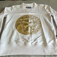 Versace Jeans Couture , Zeus Golden Medallion Sweatshirt Condition : The Product Has A Little Stain But Not Noticiable Can Be Wasable Check The Pictures , In General It Is Almost Perfect Color : White Pit To Pit : 21” Length : 26” Check The Measurements Can Be Unisex Any Question Designer White Sweatshirt With Logo Print, Designer White Long Sleeve Sweatshirt, Almost Perfect, Versace Jeans Couture, Versace Jeans, Versace, Men Sweater, Color White, Stain