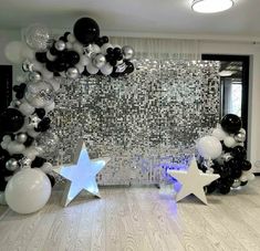 black and white balloon arch with stars and balloons