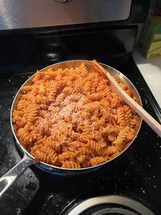 a pan filled with pasta on top of a stove