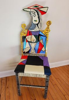 a colorful chair sitting on top of a hard wood floor