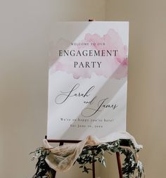 an engagement party sign sitting on top of a chair