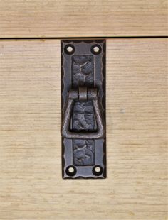 a close up of a metal latch on a wooden door