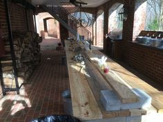 a long wooden table sitting in the middle of a room next to a fire place