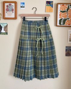 Step back in time with this adorable pleated wrap skirt, inspired by the classic charm of the 1950s. Made from 100% vintage wool, this skirt is both cozy and stylish, perfect for adding a retro flair to your wardrobe. The playful double bow closure adds a cute, eye-catching detail, while the pleated design gives it a flattering shape and flow. Whether you're dressing up for a special occasion or adding a vintage touch to your everyday look, this skirt is a fun and fashionable statement piece you'll love to wear. Key Features: - 100% wool shell - Partial satin lining - Hook closure at waistband - Cotton ties at the front princess seam Size:  - waist 24" - hips 36" - length 27.75" Sew Embroidery, Wool Wrap Skirt, Xmas 2024, Double Bow, Wool Wrap, Cottagecore Aesthetic, Step Back, Wool Skirts, Art References