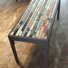 a bench made out of magazines sitting on the floor