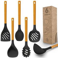 six kitchen utensils with wooden handles in front of a cardboard box and packaging