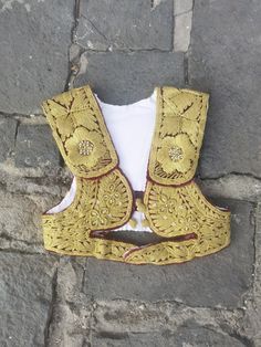 This is an all handmade vintage vest, hand embroidered with gold thread (also known as 'srma' or Ottoman name 'sirma'.) It was made by the Ottoman patterns and style of embroidery left on the Balkans as a cultural inheritance of their five century ruling at the Balkans.  The vest was made in the 1960's or the 1970's and it is kept in an excellent condition, without damages of any kind. The vest is girl size, for the age between 10-12 years old, with a chest circumference of 65 cm (25.6 inches). Gold Thread Embroidery, Style Ottoman, The Balkans, Ottoman Styling, Embroidery Hand, Girls Vest, Gold Girl, Vintage Vest, Thread Embroidery