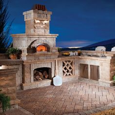 an outdoor pizza oven is lit up at night