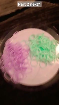 two different colored hair sitting on top of a white plate with green and pink dye