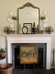 a living room with a fire place and a painting on the mantel above it