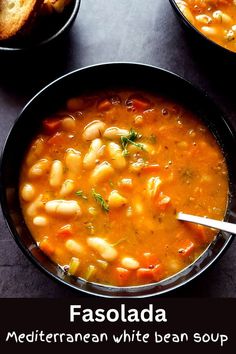 White beans soup served in a black bowl with a spoon Simple Greek Food Recipes, Greek Bean Soup Fasolada, Soup Recipes Greek, Greek Fasolada Soup, Greek Bean Soup, Fasolada Soup Greece, Fasolatha Soup, Fasolada Soup, Greek Soup Recipes