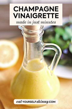 a bottle filled with liquid sitting on top of a cutting board next to lemons