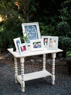 an old table with pictures and chalkboard on it