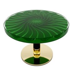 a green glass table with gold base