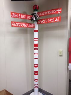 a pole with street signs on it in an office cubicle decorated to look like santa's workshop