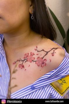 a woman with a flower tattoo on her chest