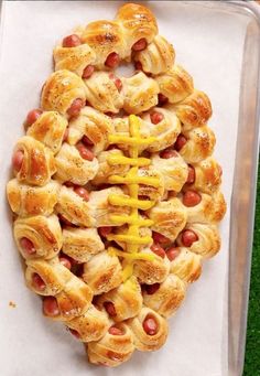 hotdogs wrapped in crescent rolls with mustard on them are ready to be eaten