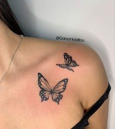 two butterflies on the back of a woman's shoulder