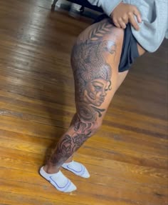 a woman's leg with tattoos on it