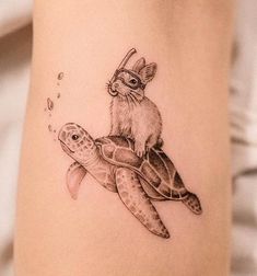 a tattoo with a rabbit riding on top of a turtle