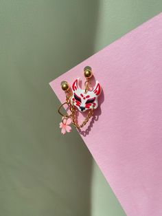 Asian style mismatched earrings with a Kitsune mask and Sakura flower. This pair of earrings was created with love to a Asian culture. If you like the japanese, korean or chinese culture - these asymmetric earrings are made for you! ◾Kitsune mask and Sakura flower are handmade with polymer clay. This material is durable, lightweight, won't lose its color over the years, and is easy to care for. ◾The ball-shaped posts are made of brass and have a 24k gold plating. Gold plating adds an additional Korean Jewelry Earrings, Sakura Polymer Clay, Sakura Jewelry, Geisha Jewelry, Japanese Style Earrings, Kitsune Earrings, Bunny Mask, Kitsune Mask, Japanese Mask