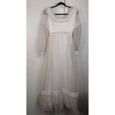 This Vintage 80s Dress Is A Beautiful Addition To Any Wardrobe. With A Bohemian Look And A Maxi Style, It's Perfect For A Wedding Or Any Special Occasion. The Ivory Color And Ribbon Detailing Add A Touch Of Elegance To The Dress. The Dress Is Made In The United States And Is An Original Piece From The 1980s. It's A Size 8 And Fits Regular Size Types. The Dress Is Perfect For Anyone Who Loves Vintage Clothing And Wants To Add A Touch Of History To Their Wardrobe. Good Preowned Condition Needs To Be Cleaned. Approx Measurements Are In The Photos White Vintage Long Sleeve Dress With Lace Trim, White Vintage Long-sleeve Dress With Lace Trim, White Vintage Dress With Lace Trim For Formal Occasions, Vintage White Long Sleeve Dress, Formal White Vintage Dress With Lace Trim, White Retro Formal Dress, White Vintage Dress For Formal Occasions, White Classic Vintage Dress For Formal Occasions, White Vintage Classic Formal Dress