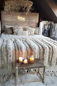 a bed with two candles sitting on top of it